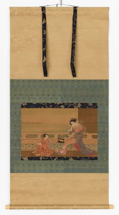 Two girls on a balcony overlooking the sea