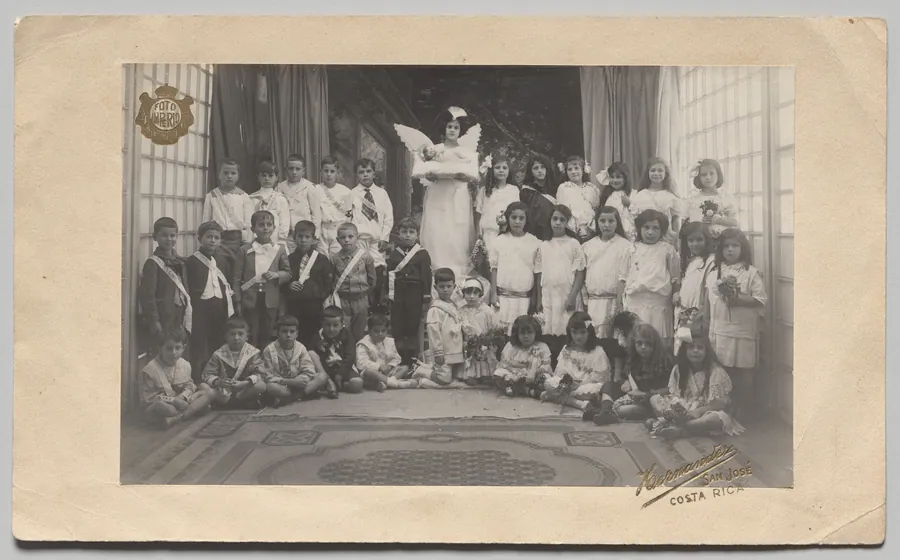 Untitled (Semi-Circle of Children, Central Girl Dressed as an Angel Holding the Baby Jesus) by Andrés and Francisco Hernández