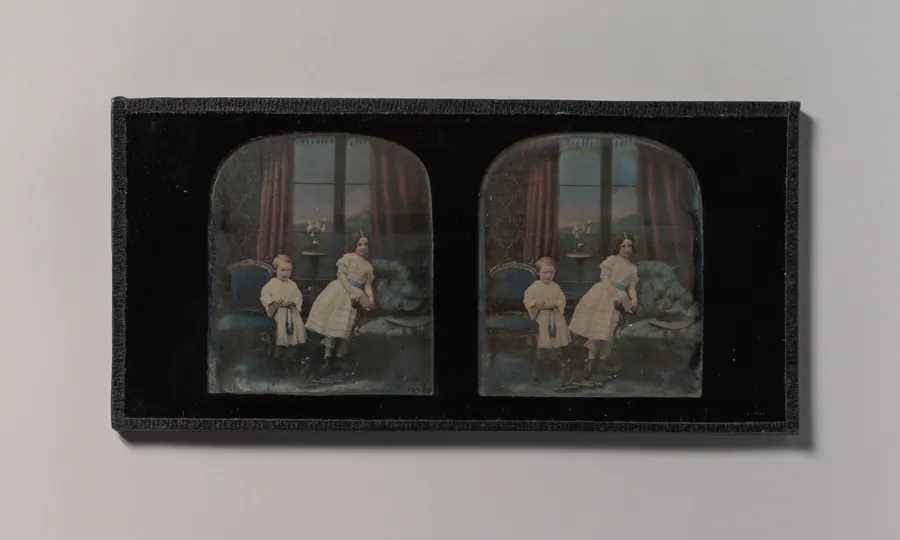 [Stereograph, Two Children Standing Between Furniture in a Studio Parlor Setting] by Antoine-François-Jean Claudet