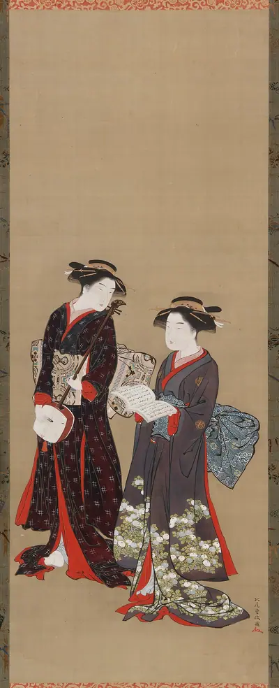 Two girls standing, one holding an open book