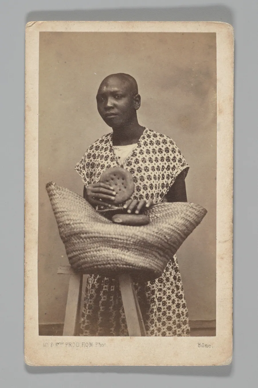 [Studio Portrait: Woman with Straw Basket, Algeria] by Maison Prod'hom
