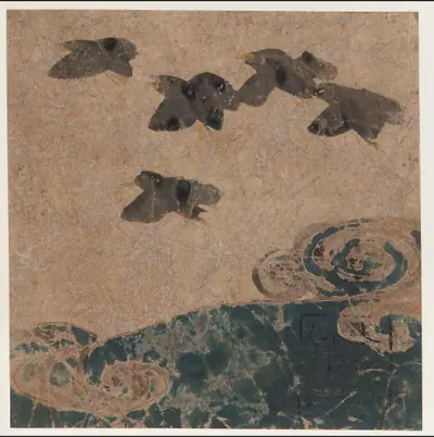 Birds flying over waves