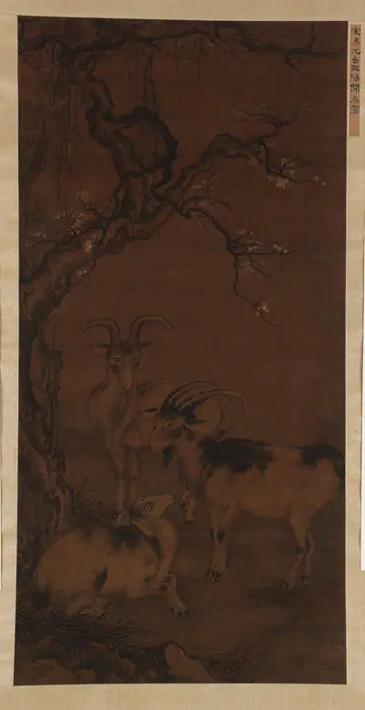 Three goats under a flowering plum tree