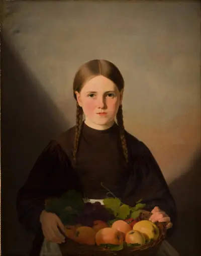 En pige med frugter i en kurv