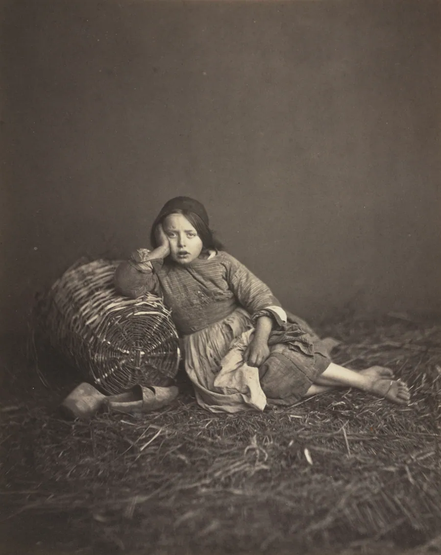 Young Girl Seated on Straw, Leaning on a Basket by Edmond Bacot