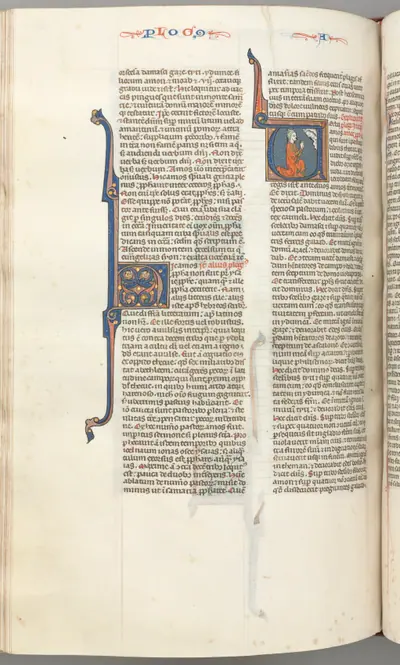 Fol. 354v, Amos, historiated initial V, Amos kneeling in prayer, bust of God above