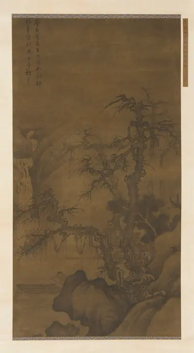 Fisherman boating under winter trees