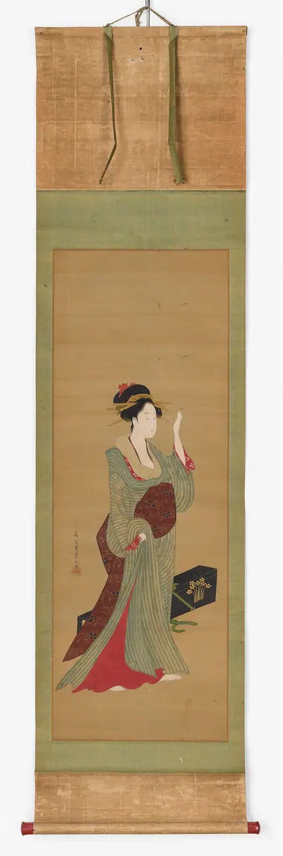 A geisha about to adjust a tortoise-shell hairpin