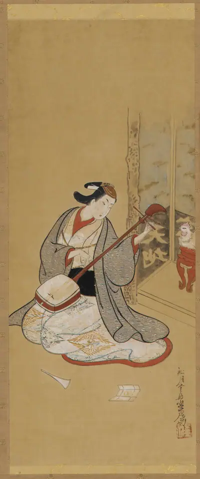 An actor in female dress stringing a samisen
